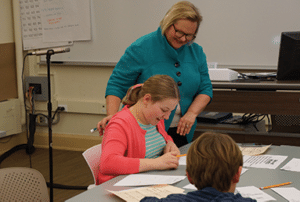 Peggy Schaefer Whitby helps a student with ASD in math word problem solving.